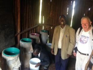 Jim Collinson inspects some bio-sand filters with friends at a Kenya primary school.
